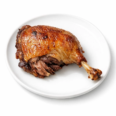 Duck young duckling domesticated white pekin leg meat and skin bone in cooked roasted
