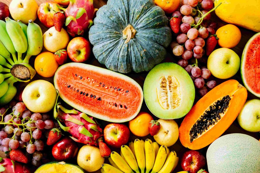 Assorted fresh fruits like watermelon, papaya, bananas, and grapes, colorful paleo friendly foods rich in essential nutrients and natural sugars.