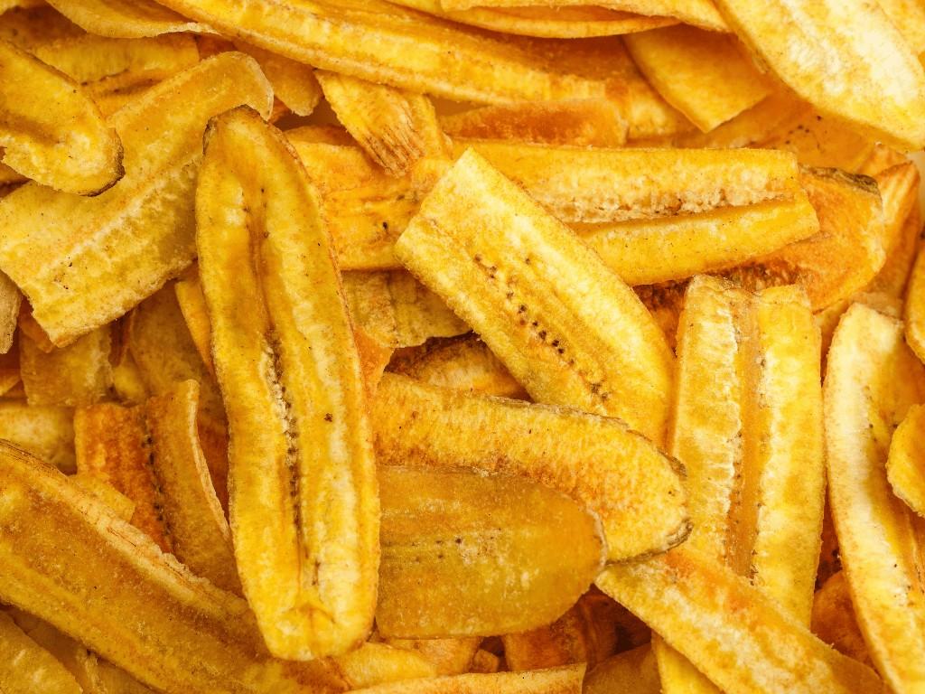 Close-up of crispy banana chips, showing a naturally sweet gluten-free snack made by baking or dehydrating sliced bananas.