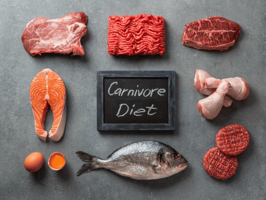 Meats, fish, and eggs on a table labeled Carnivore Diet, an animal-based foods.