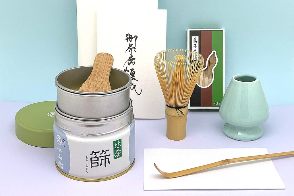 best matcha tea powder tins placed on green fabric for baking and culinary use.