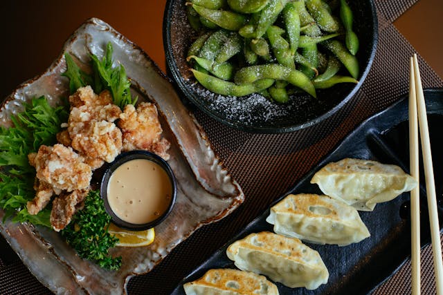 Bowl of steamed edamame pods sprinkled with salt, a nutritious gluten-free and plant-based snack high in protein.
