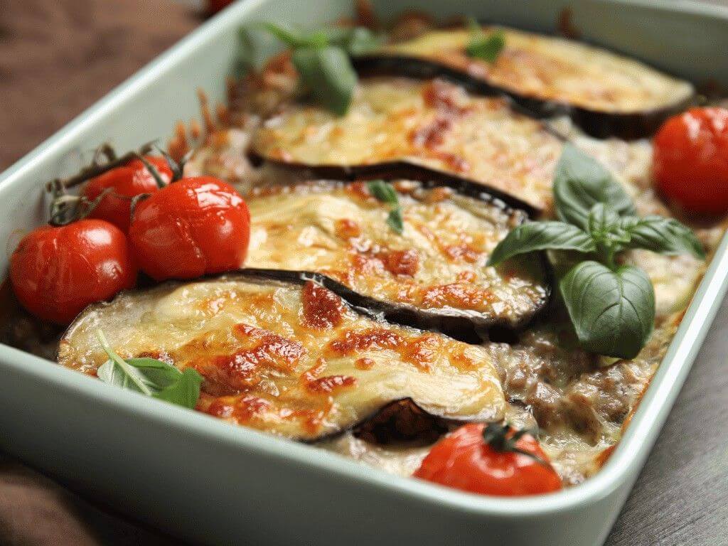 Baked eggplant lasagna with melted cheese and cherry tomatoes, a keto and low carb pasta alternative rich in healthy fats.