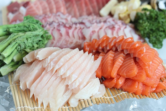 Slices of raw white fish and salmon sashimi an is sushi healthy option high in omega 3 fatty acids and lean protein.
