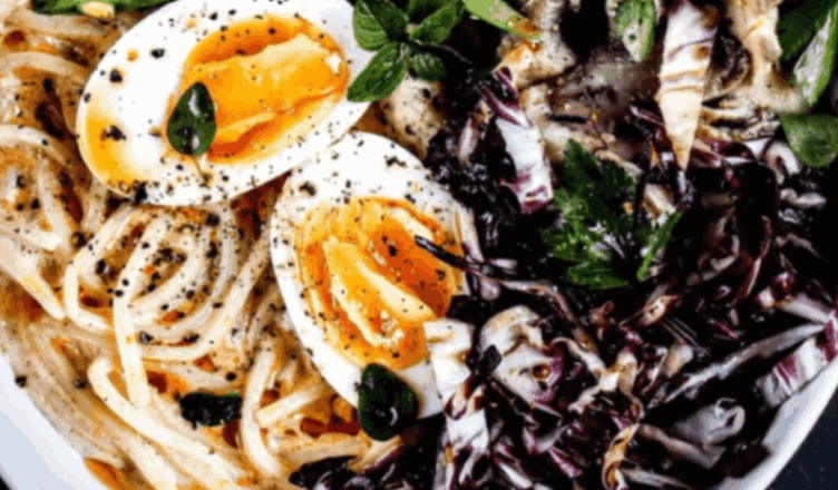 Bowl of Miracle Noodle shirataki noodles topped with eggs, mushrooms, and greens, a low carb keto friendly pasta alternative.
