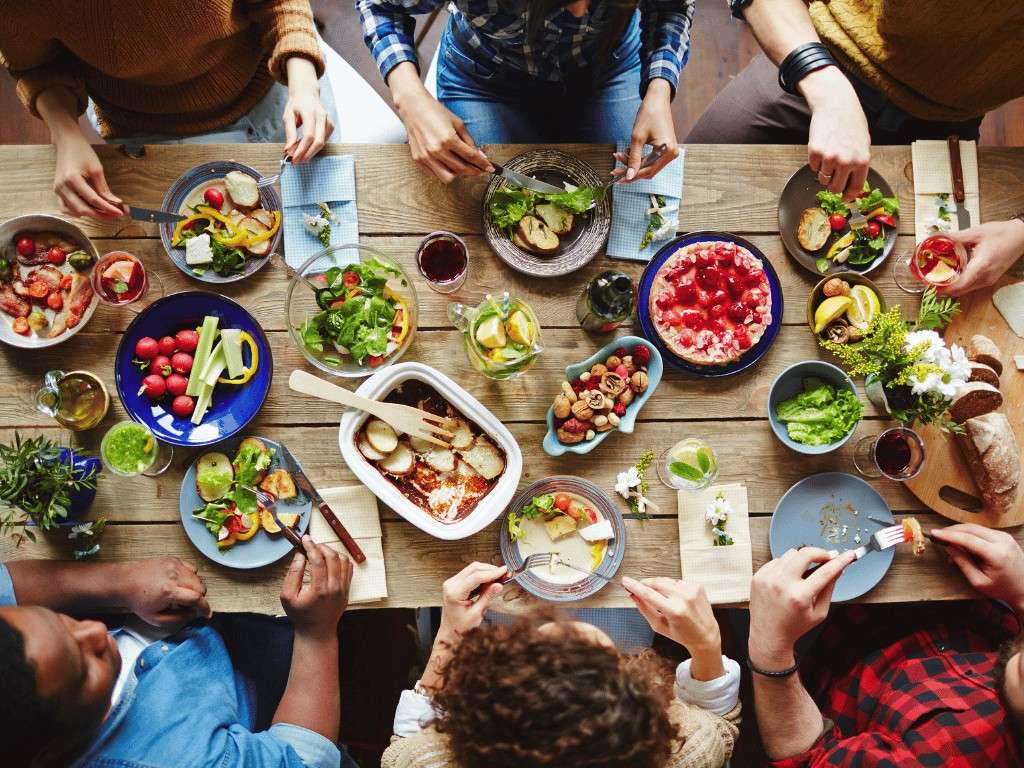 Group dining together enjoying balanced low sodium meals at a restaurant.