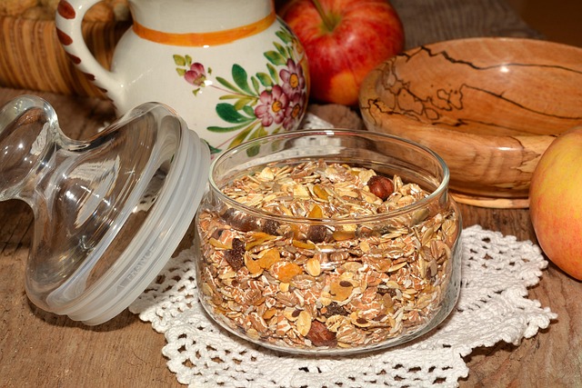 Glass jar filled with oatmeal and nuts on table, a high fiber food that supports weight loss and heart health