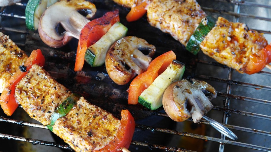 Grilled paleo skewers with chicken, zucchini, mushrooms, and bell peppers cooked in olive oil for a healthy paleo meal.