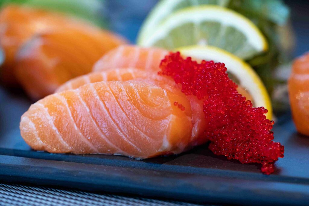 Fresh salmon with vibrant red fish roe and lemon slices, a protein rich seafood high in healthy fats and perfect for paleo diet meal plans.