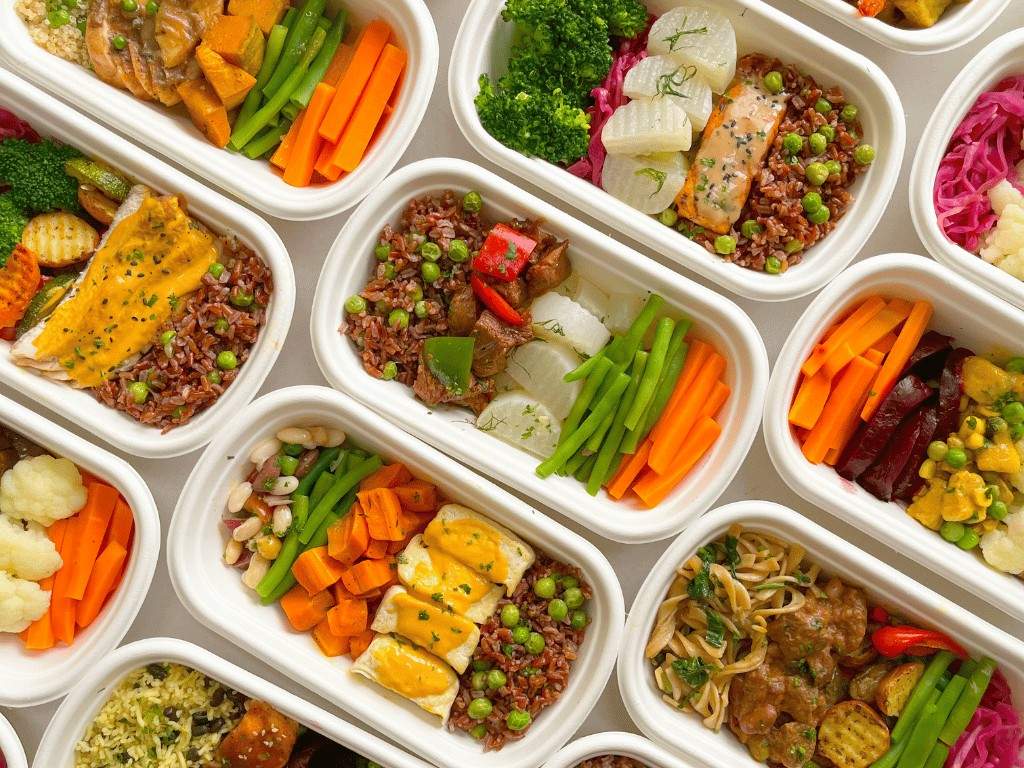 Assorted meal prep containers filled with rice, vegetables, and proteins, for weekly meal planning and healthy eating.
