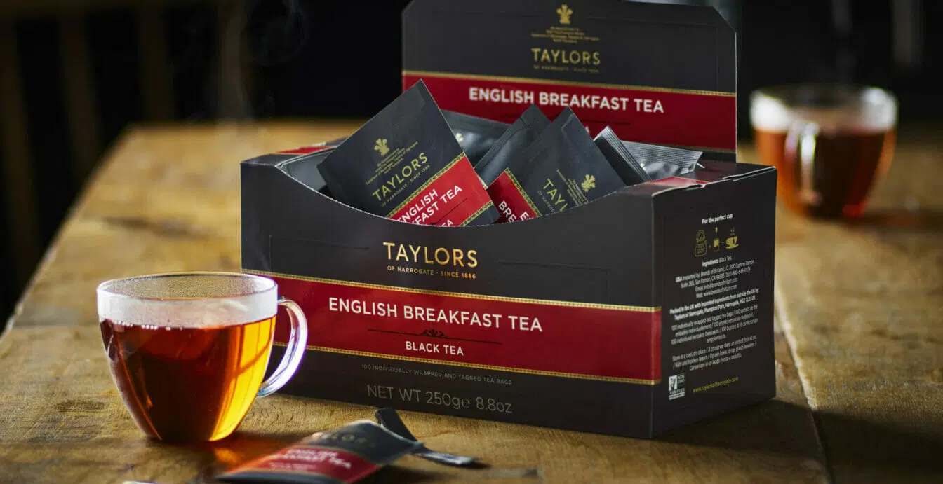 Taylors of Harrogate English Breakfast Tea box with tea bags and brewed English breakfast tea cup.