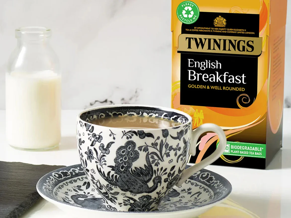Twinings English Breakfast Tea box with teacup and milk, traditional English breakfast tea setup.