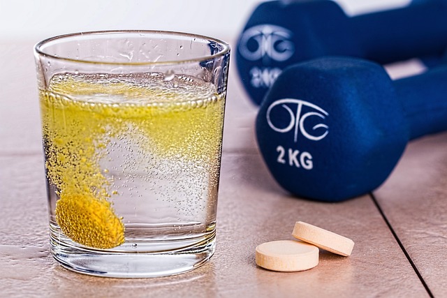 Glass of supplement drink beside dumbbells showing lifestyle habits linked to unexplained weight gain.