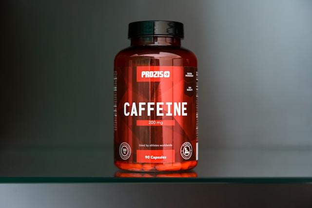 Caffeine supplement bottle on a glass surface