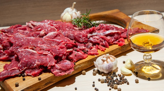 Raw meat, garlic, and olive oil showing fat based foods used in the Galveston Diet fuel refocus step