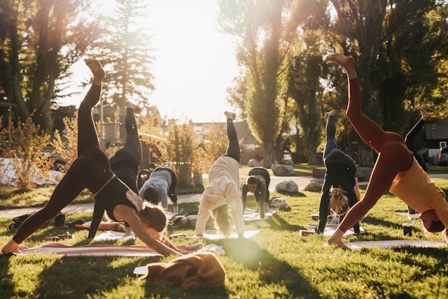 Women practicing outdoor yoga as part of the Galveston diet lifestyle for menopause and perimenopause health