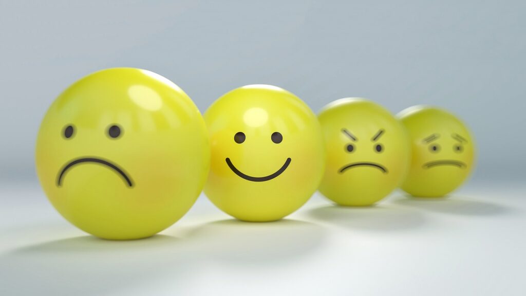 Row of smiley face balls showing changing moods as aspartame in Coke Zero may affect serotonin and dopamine levels.