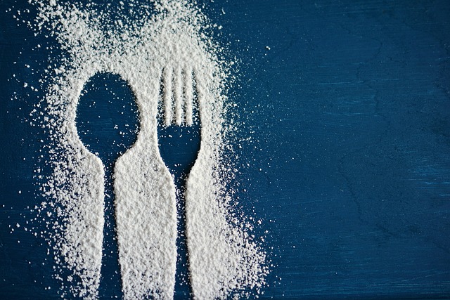 Sugar arranged in the shape of a spoon and fork. Diet soda sweetness can trigger insulin responses even without real sugar.