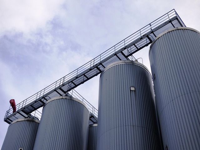 Large milk processing silos in a dairy facility showing where raw milk is heated and cooled during pasteurization.