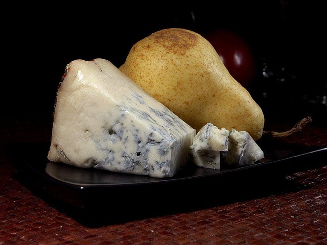 Slice of unpasteurized blue cheese show how contaminated dairy and raw milk products can cause foodborne intoxication.