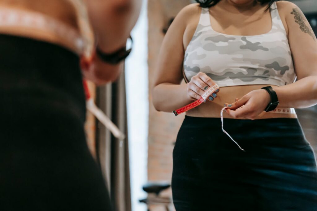 Person measuring waist with a tape measure, does lexapro cause weight gain?