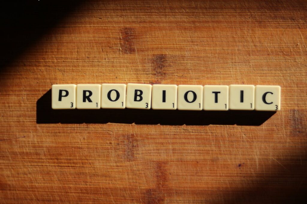 Wooden letter tiles spelling “probiotic” on a table