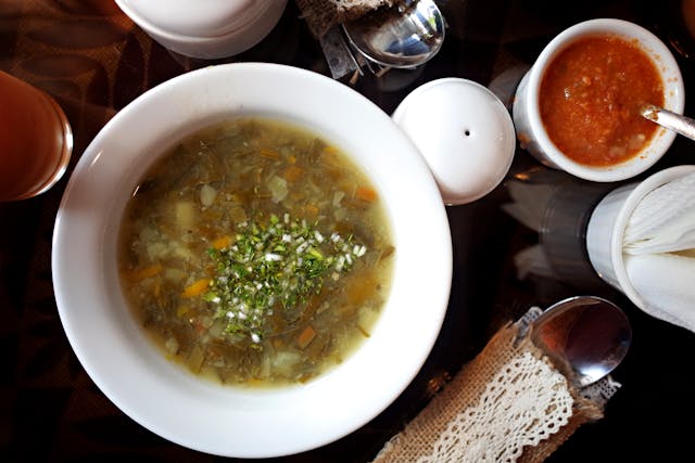 Bowl of broth on a table, good for breaking a fast safely.